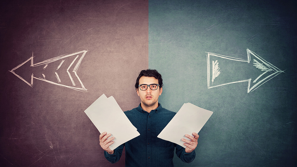 Arrows pointing in different directions with a man looking unsure of which way to go